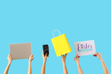 Women with laptop, payment terminal and shopping bag on blue background. Easter Sale