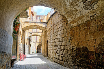 Fototapeta na wymiar Beautiful arched street in the medieval old town of Orvieto, Umbria, Italy