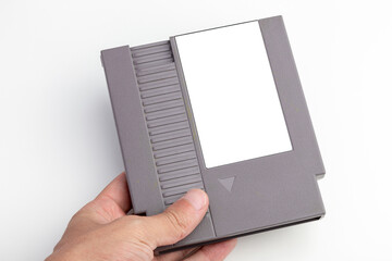 hand holds game cartridge with blank label