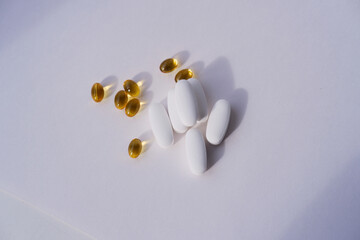 vitamin d capsules and magnesium citrate tablets close-up on a white background. dietary supplements
