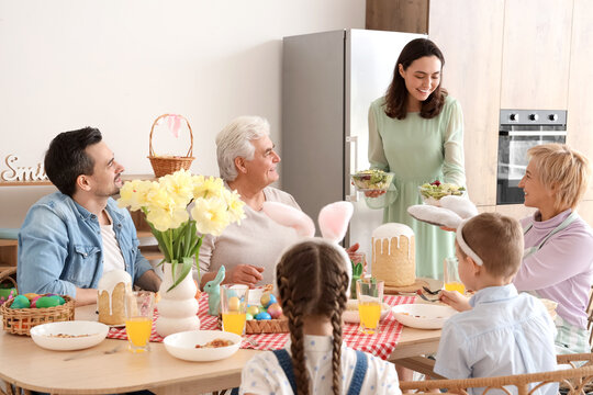 Young woman bringing salad for Easter dinner with her family at home