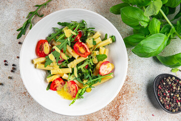 pasta salad tomato, arugula, boiled pasta fresh food tasty healthy eating cooking appetizer meal food snack on the table copy space food