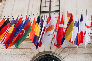 National flags of various countries flying in the wind. Colorful flags from different countries....