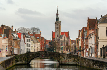 Beautiful view of the famous Spiegelrei canal with the famous Poortersloge square and Jan van Eyck in the background, in February, Bruges, Flanders region, Belgium.