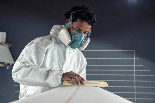 Shaper working on surf board