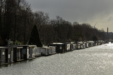 Utrecht in the Netherlands. 25 February 2023. Houseboats in Utrecht on a grey day with low sun reflecting in the water.