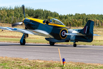 A World War II Mustang IV fighter aircraft about to take oiff.