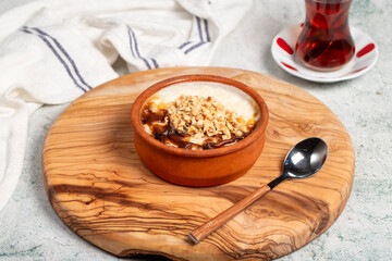 Rice pudding dessert. Milky dessert. Oven rice pudding on gray background. Local name sütlaç