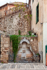 Old ottoman fountain of the late 18th century, with religious writings in ottoman alphabet, in the old town of Nafplio, in Peloponnese region, Greece, Europe. 