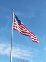us flag on a mast streaming on wind, blue sky for background