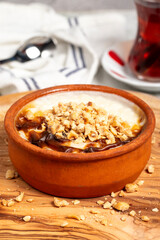 Rice pudding dessert. Milky dessert. Oven rice pudding on gray background. Local name sütlaç