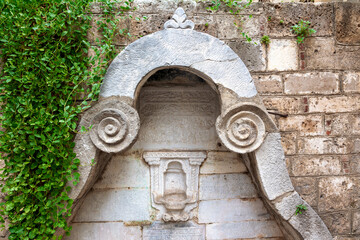 Old ottoman fountain of the late 18th century, with religious writings in ottoman alphabet, in the old town of Nafplio, in Peloponnese region, Greece, Europe. 