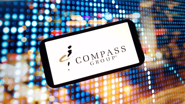 Konskie, Poland - March 02, 2024: Compass Group company logo displayed on mobile phone screen