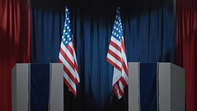 Medium full no people shot of debate hall or TV studio with red, blue drapes in background, American flags, two podiums with microphones, prepared for public electoral debates