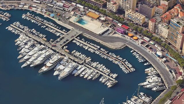 Circular movement around of an ancient beautiful place surrounded by flying. Circular movement around the Monaco marine. Aerial panning shot of famous marine in Monte Carlo, Monaco