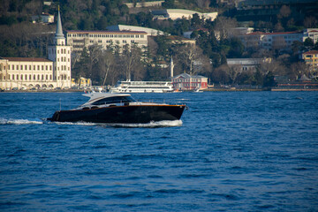Power boat taxi in Bosphorus Strait moving fast and splashing water. Anatolian Site of Istanbul and...
