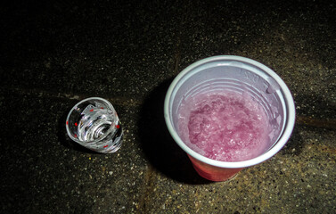 Pour vodka shot glasses and drink cheers in Germany.