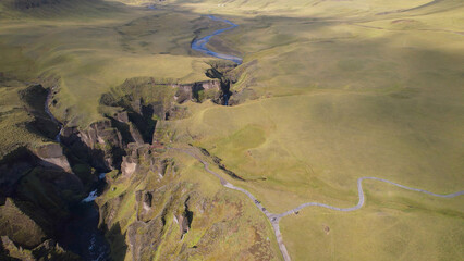 Fjadrargljufur (or Fjadra Canyon) is a 100 m deep and about 2 kilometres long serpentine canyon with the Fjaðrá river flowing through it, South Iceland.