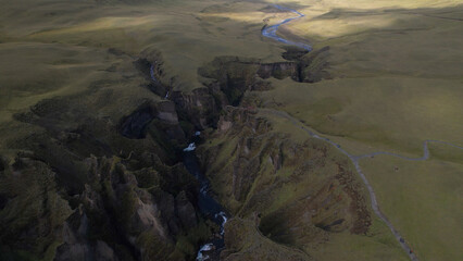 Fjadrargljufur (or Fjadra Canyon) is a 100 m deep and about 2 kilometres long serpentine canyon with the Fjaðrá river flowing through it, South Iceland.