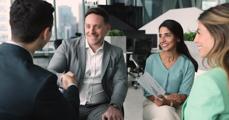 Friendly male leader boss shake hand client or workmate start, finish formal meeting in modern office. Professional businesspeople reached agreement, make deal, feel satisfied with negotiation result