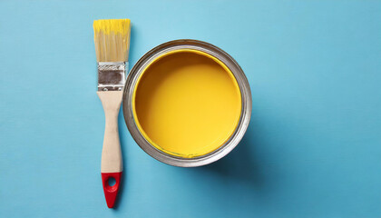 Metal can with yellow paint and brush. Flat lay on blue - Powered by Adobe