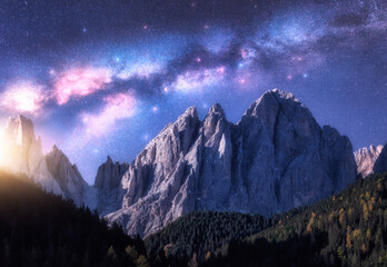 Milky Way and beautifull rocks at starry night in summer in Dolomites, Italy. Landscape with blue sky with stars, bright milky way, moonrise over high alpine rocky mountains, forest. Space. Nature