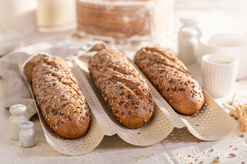 Crispy wholegrain baguettes in a rustic home bakery.