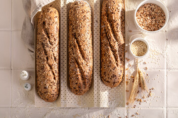 Hot wholegrain baguettes baked on a special baking tray.