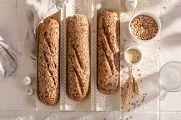 Hot wholegrain baguettes baking in sesame and flax seeds.