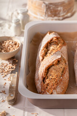 Homemade baguettes baked in a bright rustic kitchen.