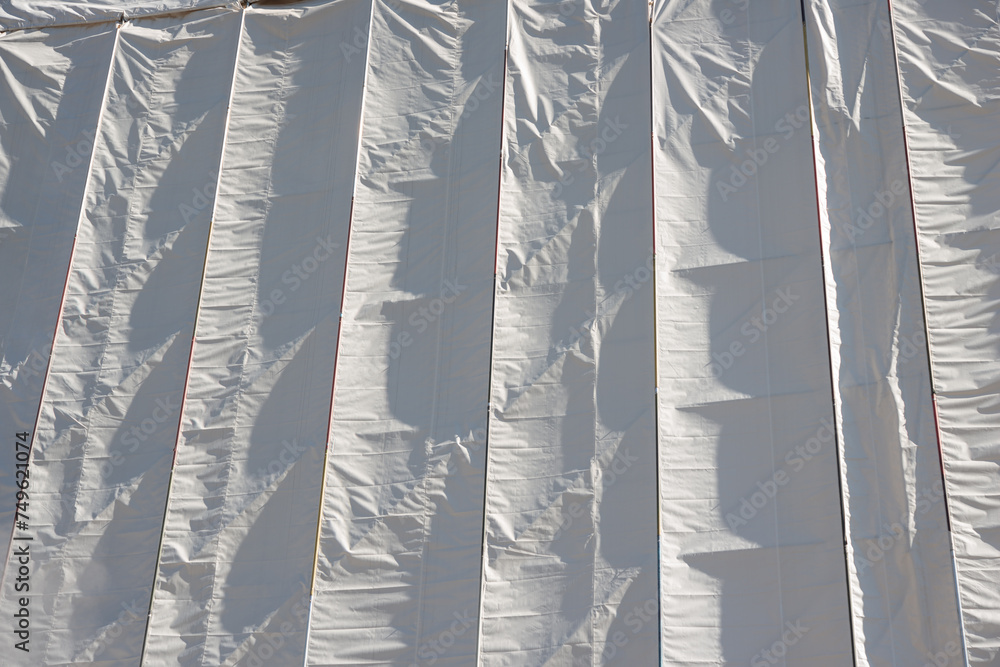 Wall mural white tarp on the outside of a wooden structure