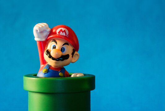 Rio de Janeiro, Brazil. January 30, 2019. Super Mario with pipe toy figure. There are plastic toy sold as part of the McDonald`s Happy meals. Isolated on blue background.	