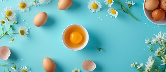 A flat lay arrangement featuring a bowl filled with boiled chicken eggs and fresh daisies on a vibrant blue background. The top-down view captures the contrast between the white eggs and yellow - Powered by Adobe