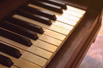 Close-up of the keys of an old piano, in a vintage style with yellowed keys. Image of a musical...