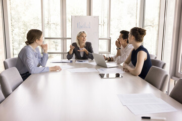 Negotiations or business training of young and mature businesspeople. Four business partners...