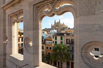 Cathedral of Palma de Mallorca seen from the terrace of La Lonja building through a large window,...