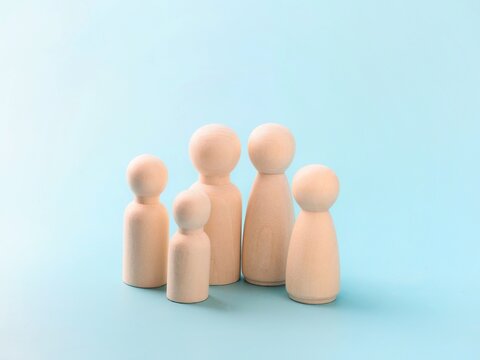 Large family concept: a family of five members made of wooden peg dolls
