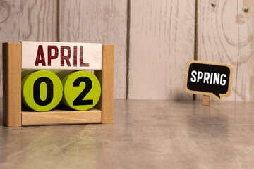 2 April on wooden grey cubes. Calendar cube date 02 April. Concept of date. Copy space for text or event.