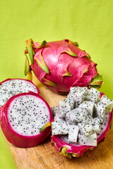 Red dragon fruit Set with appetizing serving on green background. Top view