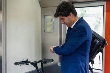 Businessman Commuting with Electric Bicycle in Metro Carriage