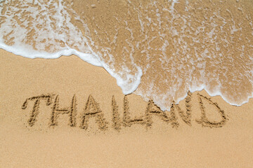 Thailand written in a sandy