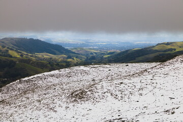View of San Ramon Valley from the snowy East Bay hills after a cold winter storm