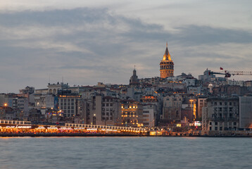 Fototapeta na wymiar Beyoglu District Waterfront, Galata Tower and Galata Bridge at Sunset