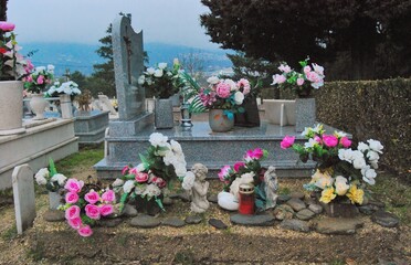 Reflect on social hierarchy in a Catholic cemetery. Even in death, distinctions persist, shaping...