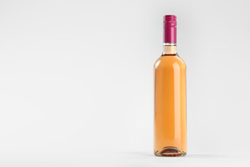 Bottle of expensive rose wine on light background. Space for text