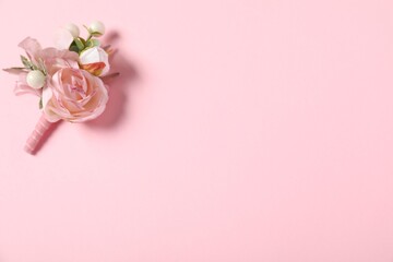 Stylish boutonniere on pink background, top view. Space for text