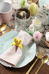 Festive table setting with napkin ring in shape of bunny ears, closeup. Easter celebration