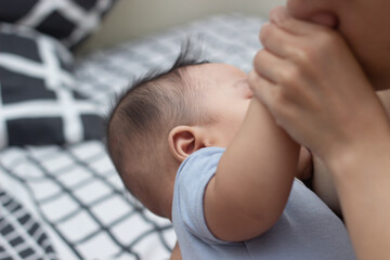 Asian baby boy is breastfeeding.