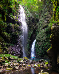 brave hiker girl admiring hidden gem of lamington national park - thunder and lightning falls;...