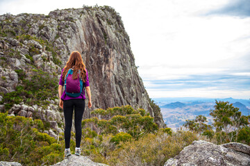 hiker girl admiring the panorama of mountains on the way to the top of mount maroon, mount barney national park, queensland, australia